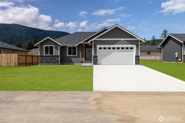 6511 Watson Loop, Maple Falls, WA 98266 - view of front facade featuring stone siding, a mountain view, a garage, concrete driveway, and board and batten siding