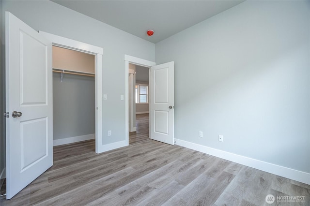 6511 Watson Loop, Maple Falls, WA 98266 - unfurnished bedroom featuring baseboards, wood finished floors, and a closet