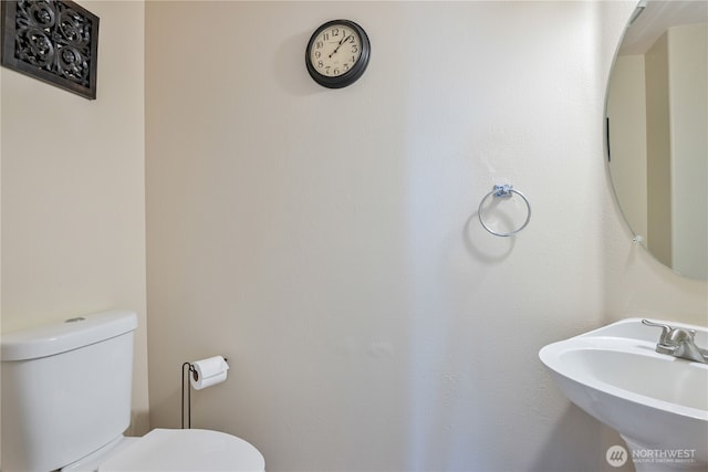 bathroom featuring toilet and a sink