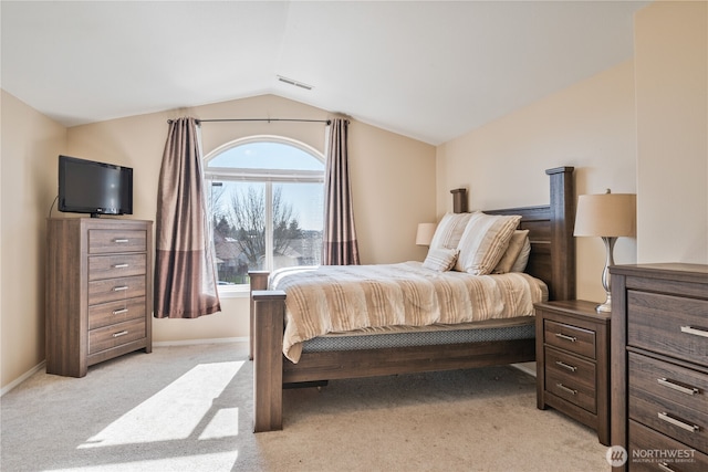 bedroom featuring visible vents, lofted ceiling, light colored carpet, and baseboards