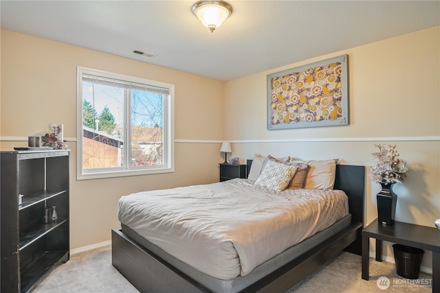 carpeted bedroom with visible vents and baseboards