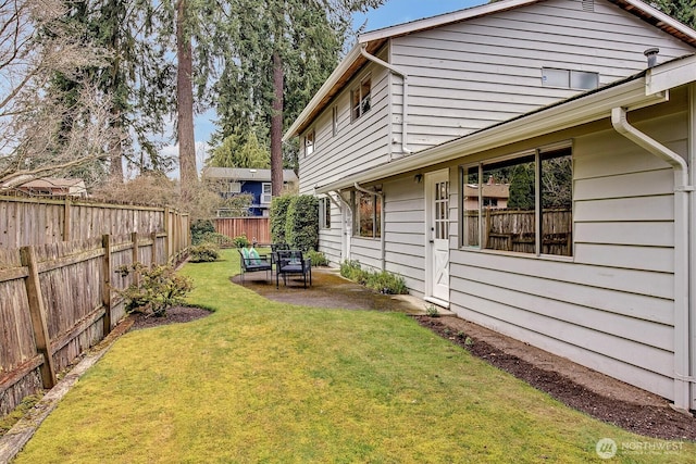 view of yard featuring a patio area and a fenced backyard