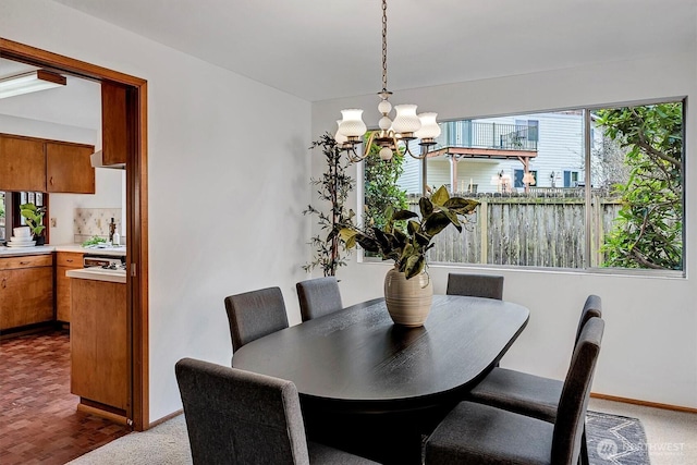 dining room with a notable chandelier and baseboards