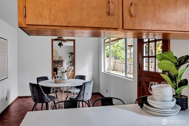 dining area with a fireplace and baseboards