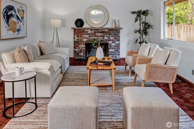 living area with a brick fireplace, brick floor, and baseboards