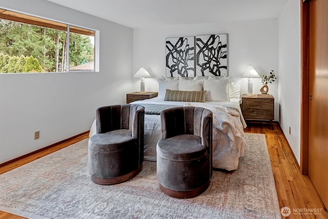 bedroom with baseboards and wood finished floors