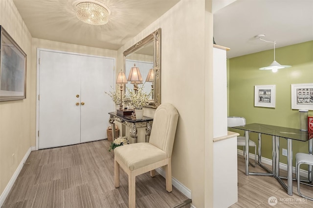 foyer with wood finished floors and baseboards