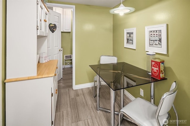 dining room with light wood-style floors and baseboards