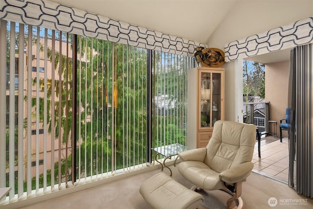 interior space with lofted ceiling and light tile patterned floors