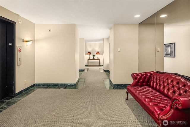 hall with carpet floors, elevator, baseboards, and recessed lighting