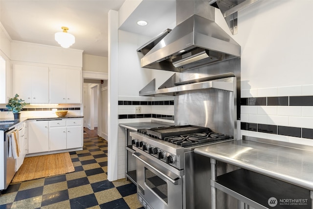 kitchen featuring white cabinets, stainless steel countertops, dark floors, high end range, and island exhaust hood