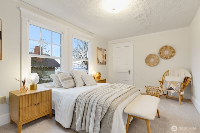 bedroom with light carpet, crown molding, a textured ceiling, and baseboards