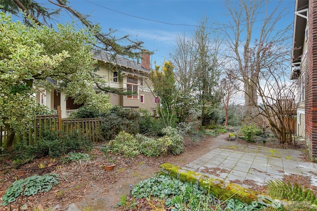 view of yard featuring fence and a patio