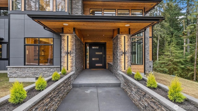 doorway to property with stone siding