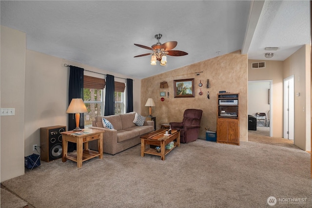 carpeted living area with lofted ceiling, visible vents, and ceiling fan