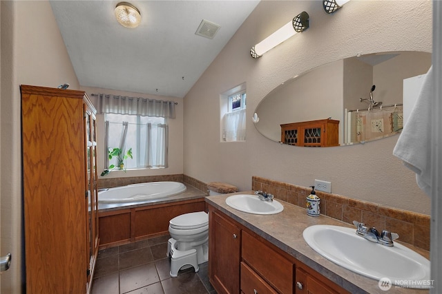 bathroom with visible vents, a sink, a garden tub, and tile patterned floors