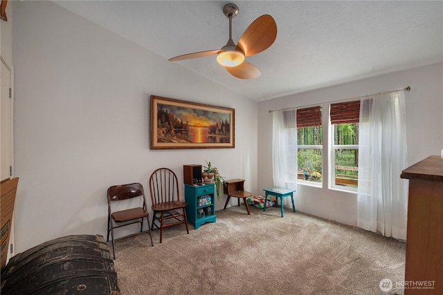 sitting room featuring lofted ceiling, ceiling fan, and carpet