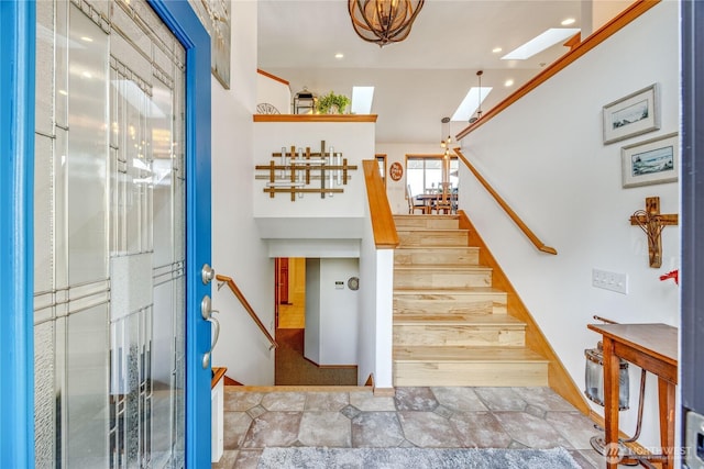 stairs with a skylight