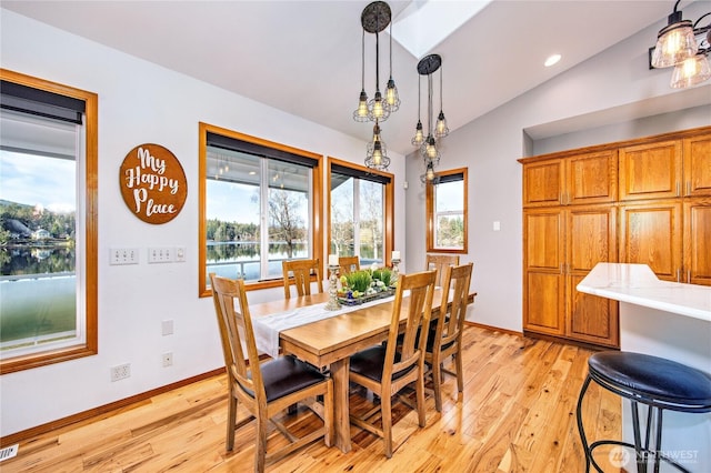 dining room featuring vaulted ceiling, recessed lighting, light wood-type flooring, and baseboards