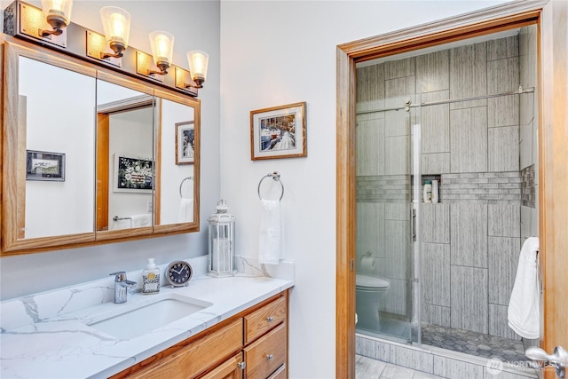 full bath with toilet, a stall shower, and vanity