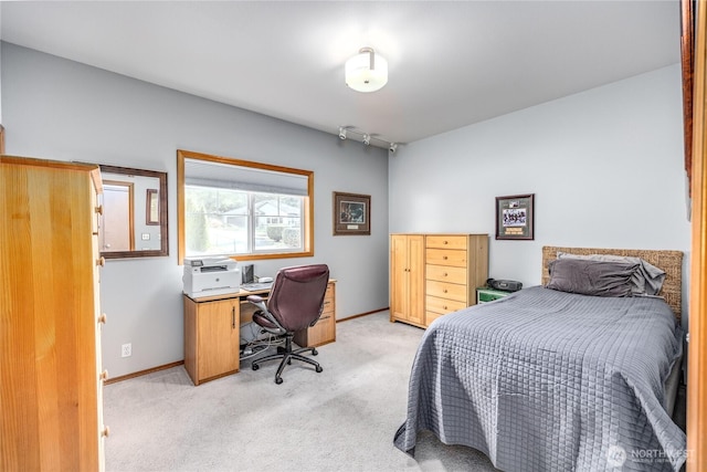 bedroom featuring light carpet and baseboards