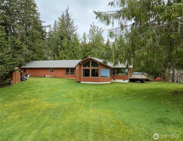 rear view of house featuring a lawn