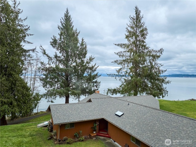 details with a water view and a shingled roof