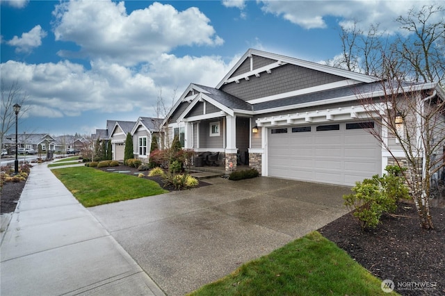 craftsman inspired home featuring a residential view, stone siding, driveway, and an attached garage