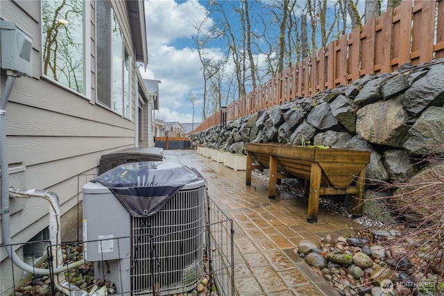 exterior space with a fenced backyard and central AC