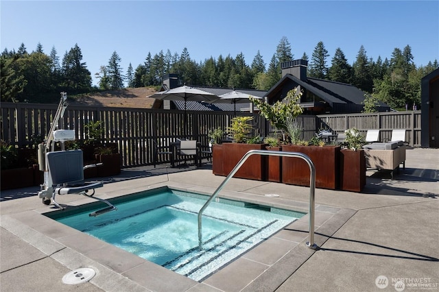 view of pool featuring a patio area, fence, and a community hot tub