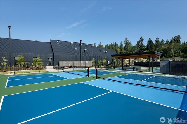 view of tennis court featuring fence