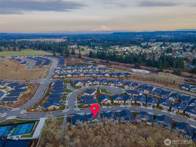 aerial view at dusk featuring a residential view