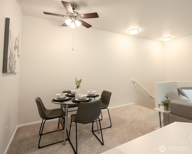 dining room with light colored carpet and baseboards