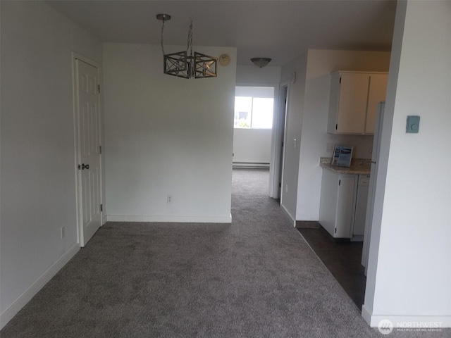 unfurnished dining area with baseboard heating, baseboards, and dark colored carpet