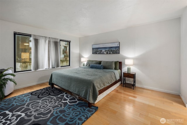 bedroom featuring hardwood / wood-style flooring and baseboards