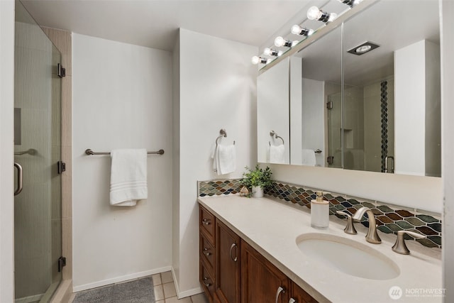 bathroom featuring a shower stall, decorative backsplash, tile patterned flooring, and vanity