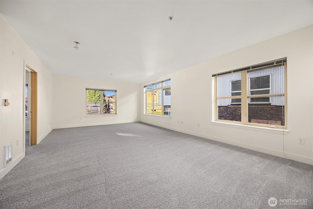 unfurnished room featuring baseboards and carpet flooring