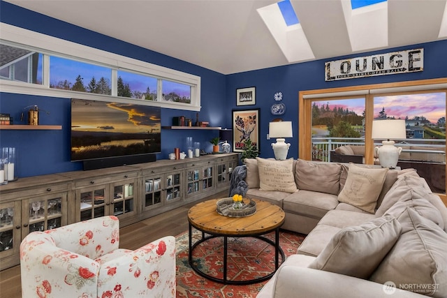 living area with a skylight and wood finished floors