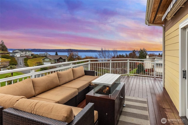 deck at dusk with an outdoor hangout area