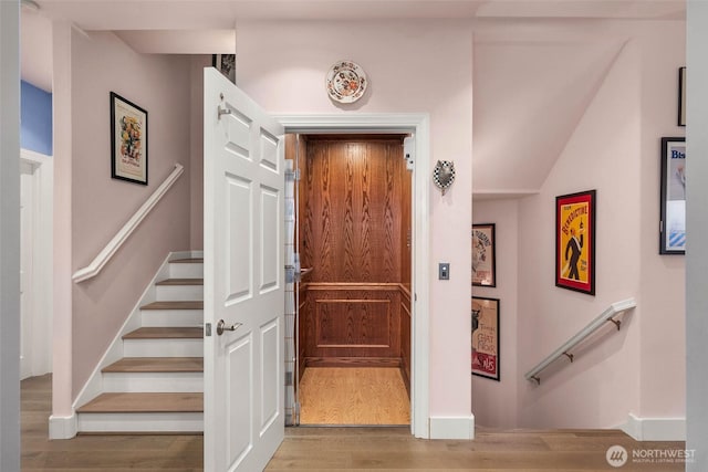 interior space with stairs and wood finished floors