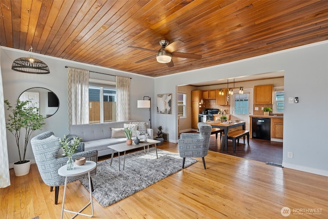 living room featuring ceiling fan, crown molding, and light wood-style floors