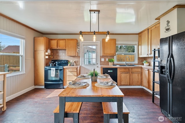 kitchen with black appliances, light countertops, dark wood-type flooring, and a sink