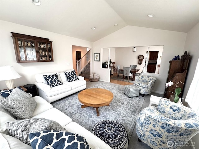 living room featuring lofted ceiling, stairway, and baseboards