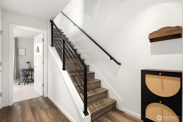 stairway with baseboards and wood finished floors