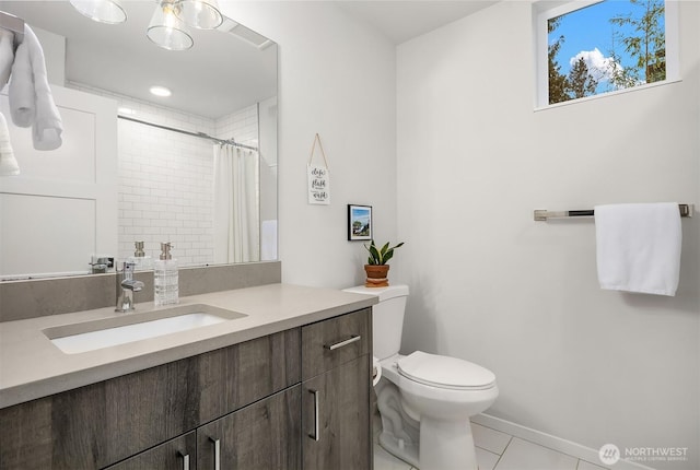 bathroom with curtained shower, vanity, toilet, and tile patterned floors