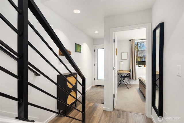 entryway with light wood-style floors, baseboards, stairway, and recessed lighting