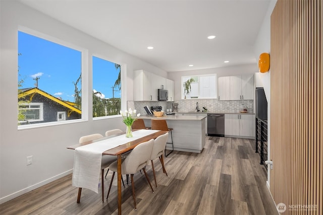 kitchen featuring black microwave, decorative backsplash, stainless steel dishwasher, and electric range oven