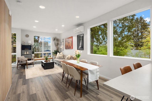 dining space with recessed lighting, wood finished floors, baseboards, and a wall mounted AC