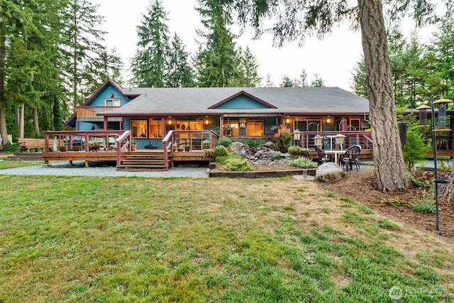 back of house with a yard and a wooden deck