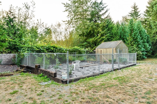 view of pool featuring a yard, a vegetable garden, an outdoor structure, and fence